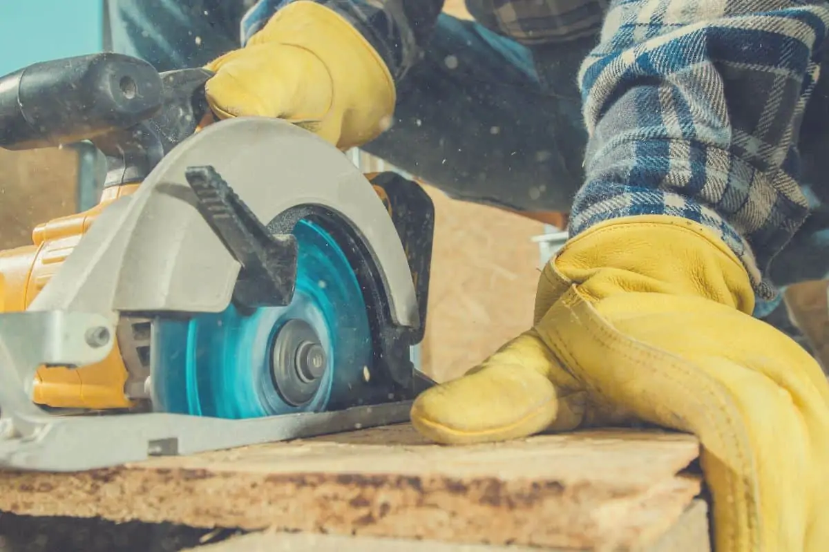 A close up of someone cutting with a circular saw